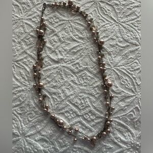 A Talbots pearl necklace in pink and gray tones on a silver necklace